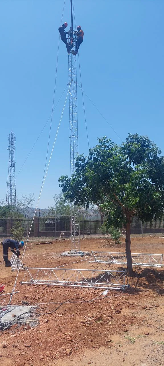 MME Networks technicians assembling and securing a regional communications tower